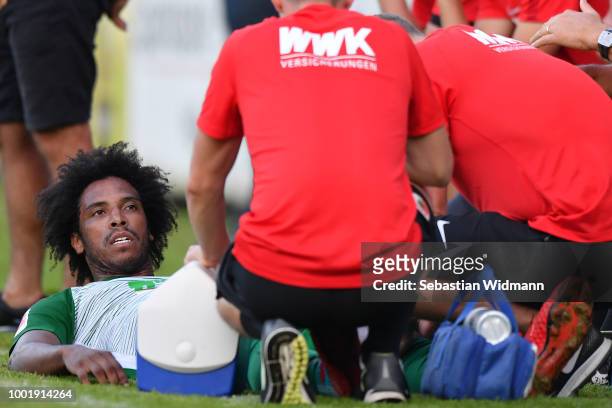 Francisco da Silva Caiuby of Augsburg is being treated on the sideline during the pre-season friendly match between SC Olching and FC Augsburg on...