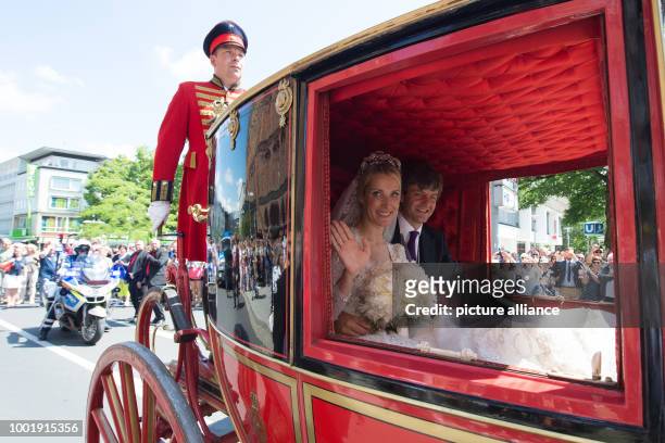 Prince Ernst August of Hanover and his wife Ekaterina of Hanover ride through the city in a historical horse carriage after their church wedding in...