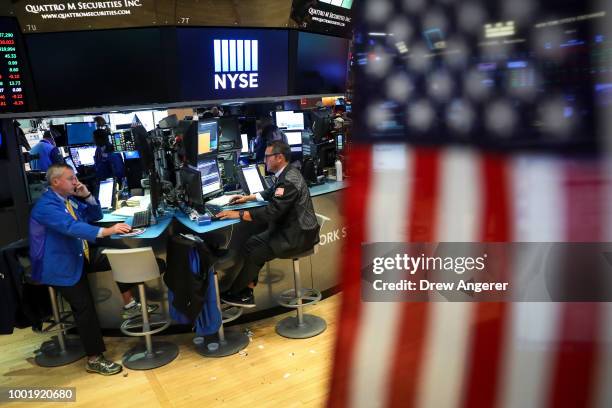 Traders and financial professionals work ahead of the closing bell on the floor of the New York Stock Exchange , July 19, 2018 in New York City....