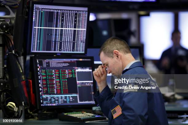 Traders and financial professionals work ahead of the closing bell on the floor of the New York Stock Exchange , July 19, 2018 in New York City....