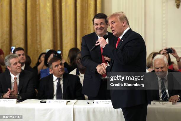 President Donald Trump shake hands with Chris Murdoch, senior advisor for Foxconn Technology Co., during a 'Pledge to America's Workers' event at the...