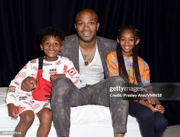 King Tucker, NBA player P. J. Tucker, and Aaliyah Tucker pose in the Green Room at the Nickelodeon Kids' Choice Sports 2018 at Barker Hangar on July...