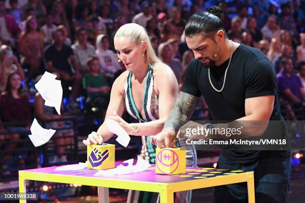 Skier Lindsey Vonn and WWE wrestler Roman Reigns participate in a challenge onstage during the Nickelodeon Kids' Choice Sports 2018 at Barker Hangar...