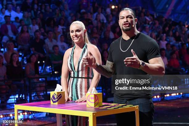 Skier Lindsey Vonn and WWE wrestler Roman Reigns participate in a challenge onstage during the Nickelodeon Kids' Choice Sports 2018 at Barker Hangar...