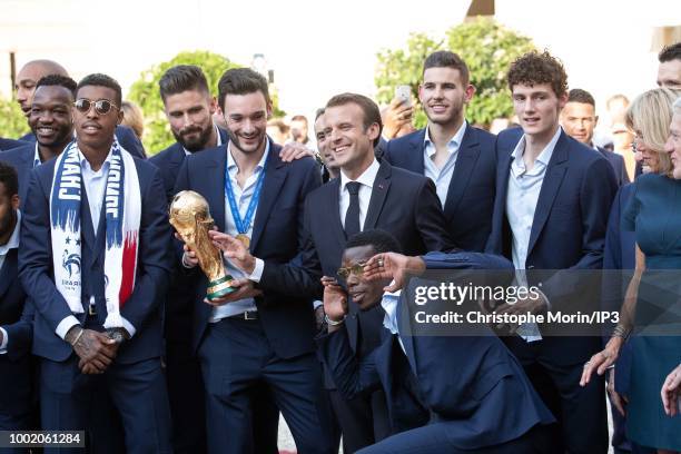 French national football team's players pose with French President Emmanuel Macron before a reception at the Elysee Presidential Palace, on July 16,...