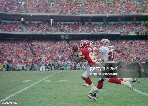 Andre Rison, Wide Receiver for the Kansas City Chiefs catches the pass as Rod Woodson, Defensive back for the San Francisco 49ers tries to intercept...