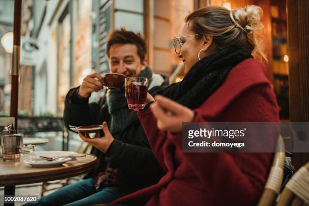 smiling best friends having fun in the outdoors bar in germany - autumn coffee stock pictures, royalty-free photos & images