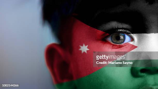 boy's face with digitally placed jordan flag on his face. - jordan stock pictures, royalty-free photos & images