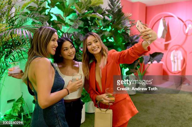 Jamie Chung poses with guests at the experiential pop-up "The Pop Shop By Vita Coco" at intimate launch party in SoHo on July 19, 2018 in New York...