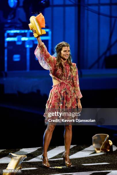 Honoree Danica Patrick is 'slimed' while accepting the Legend Award onstage during the Nickelodeon Kids' Choice Sports 2018 at Barker Hangar on July...