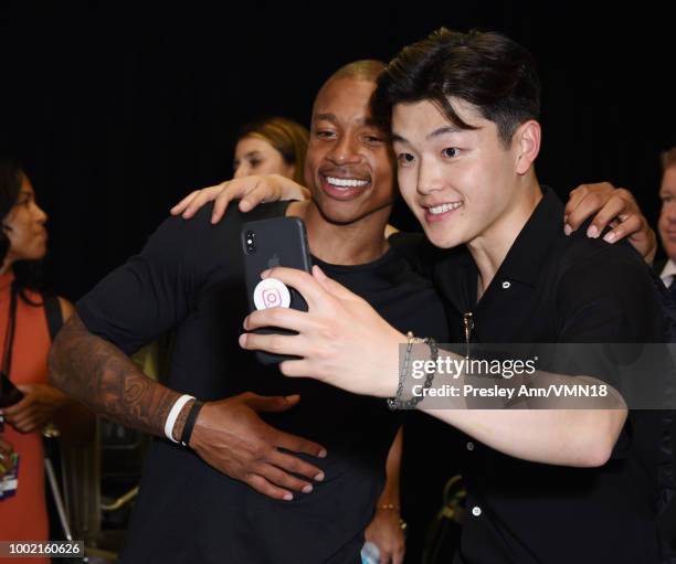 Figure skater Alex Shibutani and NBA player Isaiah Thomas pose in the Green Room at the Nickelodeon Kids' Choice Sports 2018 at Barker Hangar on July...