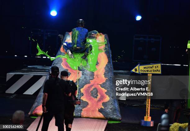 Michael Phelps participates in a challenge during the Nickelodeon Kids' Choice Sports 2018 at Barker Hangar on July 19, 2018 in Santa Monica,...