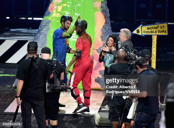 Michael Phelps, host Chris Paul, Liza Koshy and Marc Summers participate in a challenge during the Nickelodeon Kids' Choice Sports 2018 at Barker...