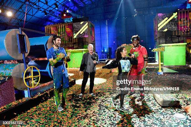 Swimmer Michael Phelps, Marc Summers, Liza Koshy, and host Chris Paul speak onstage during the Nickelodeon Kids' Choice Sports 2018 at Barker Hangar...