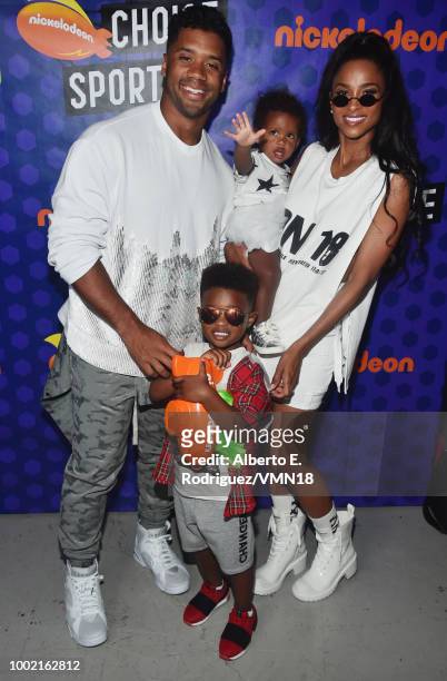 Player Russell Wilson, winner of the Best Cannon award, Future Zahir Wilburn, Sienna Princess Wilson and Ciara pose backstage at the Nickelodeon...