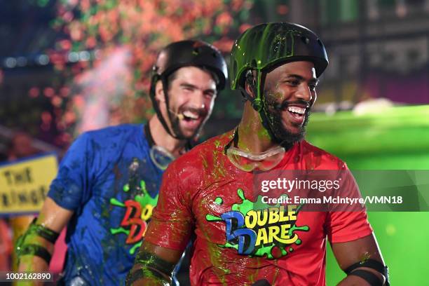 Michael Phelps and host Chris Paul participate in a challenge during the Nickelodeon Kids' Choice Sports 2018 at Barker Hangar on July 19, 2018 in...