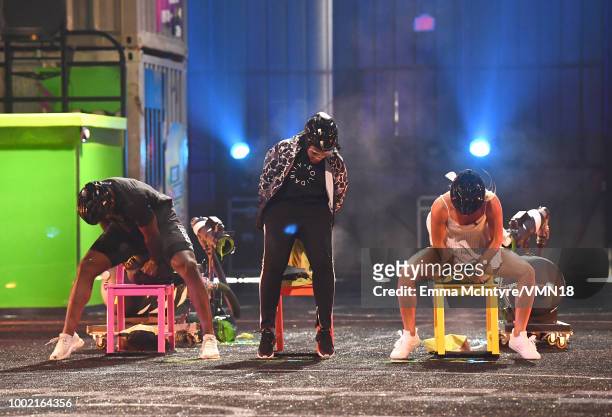 Player P.K. Subban, fencer Ibtihaj Muhammad, and skier Mikaela Shiffrin participate in a challenge onstage during the Nickelodeon Kids' Choice Sports...