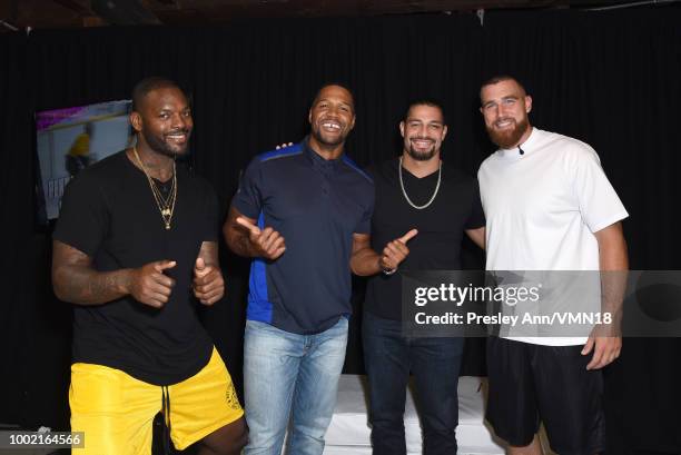 Player Martellus Bennett, former NFL player Michael Strahan, wrestler Roman Reigns, and NFL player Travis Kelce pose in the Green Room at the...