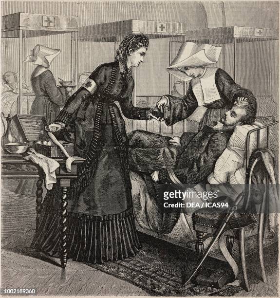 Red cross nurse and a nun treating a wounded soldier in a hospital bed, engraving from La Mode Illustree, No 41, October 9, 1870.