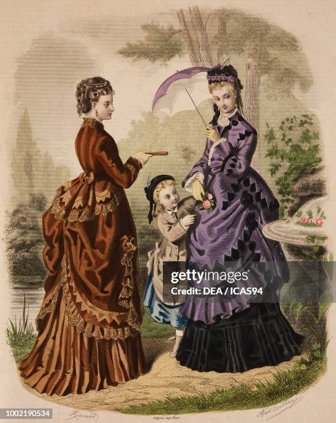 Women wearing brown and purple walking dresses with matching hats and umbrella, girl wearing a grey coat, Madame Fladry designs, France, coloured...
