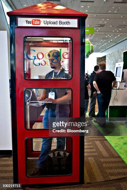 An attendee stands inside a YouTube.com upload booth during the Google I/O Developers' Conference in San Francisco, California, U.S., on Thursday,...