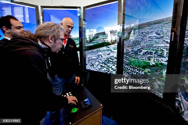 Attendees try out Google Inc.'s Earth software during the Google I/O Developers' Conference in San Francisco, California, U.S., on Thursday, May 20,...