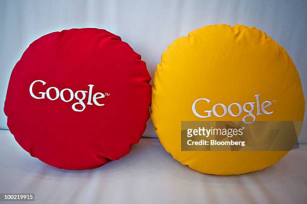Pillows stitched with Google Inc.'s logo sit on display during the Google I/O Developers' Conference in San Francisco, California, U.S., on Thursday,...