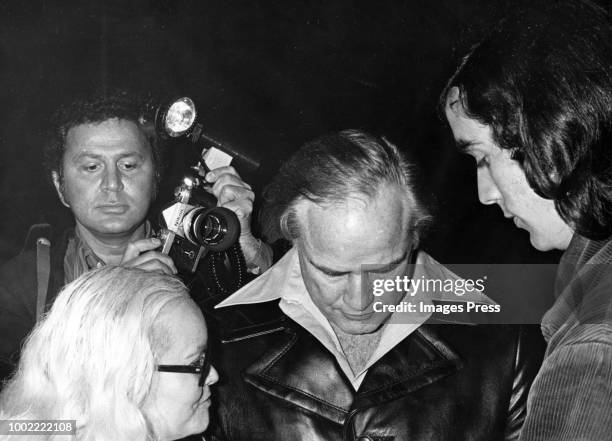 Ron Galella photographs Marlon Brando as he signs autographs at the Apollo theater on March 11, 1974 in New York City.