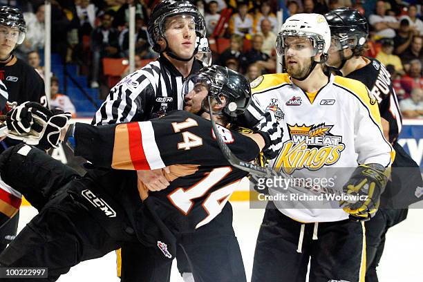 Aaron Lewadniuk of the Brandon Wheat Kings grabs on to Jimmy Bubnick of the Calgary Hitmen during the 2010 Mastercard Memorial Cup Tournament at the...