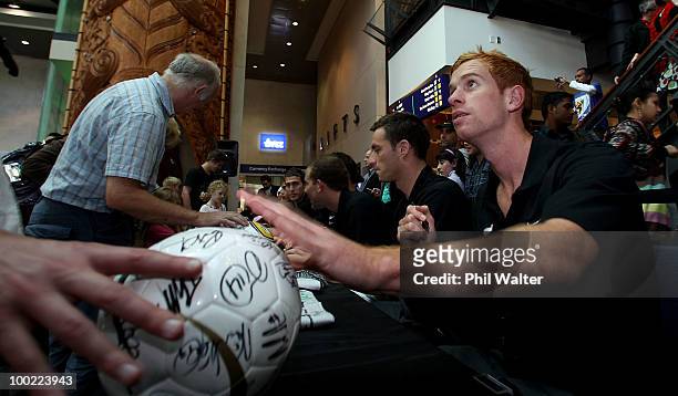 Aaron Clapham of the New Zealand All Whites signs autographs for fans during their farewell function ahead of Monday's 2010 FIFA World Cup farewell...
