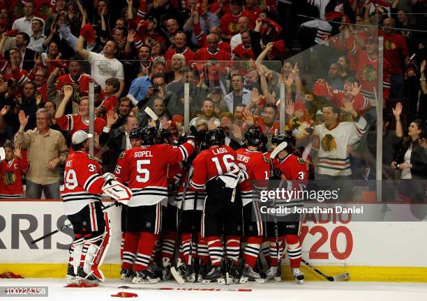 Dustin Byfuglien of the Chicago Blackhawks reacts with teammates after Byfuglien scores the game-winning goal in overtime to defeat the San Jose...