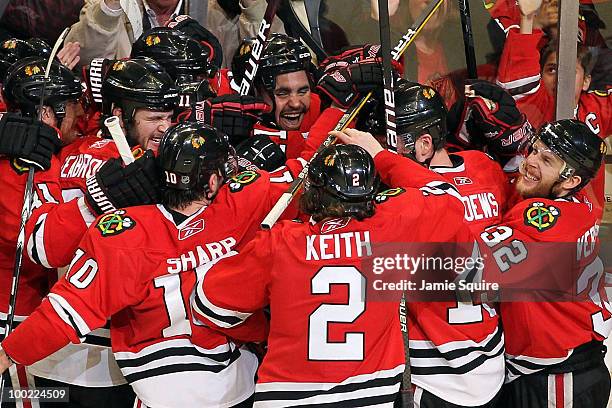 Dustin Byfuglien of the Chicago Blackhawks reacts with teammates after Byfuglien scores the game-winning goal in overtime to defeat the San Jose...