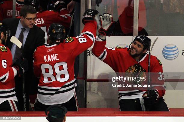 Dustin Byfuglien of the Chicago Blackhawks reacts with teammate Patrick Kane after Byfuglien scores the game-winning goal in overtime to defeat the...