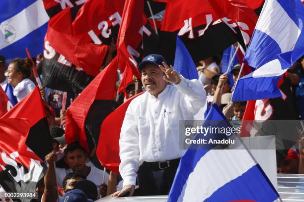 Nicaraguan President Daniel Ortega waves at supporters during the commemoration of the 39th Anniversary of the Sandinista Revolution at "La Fe"...