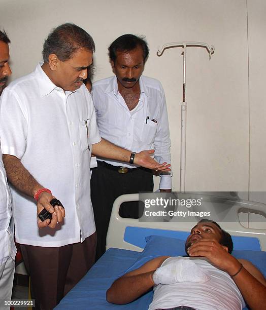 India's aviation minister Praful Patel speaks to a survivor of a plane crash, on May 22, 2010 in Mangalore. An Air India Express Boeing 737-800...