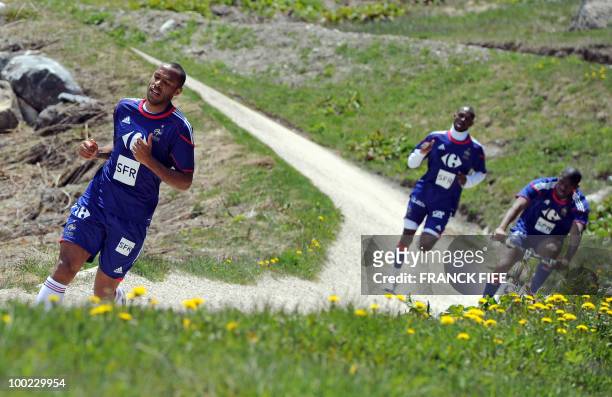 French national football team's captain Thierry Henry runs during a training session around a lake, on May 22, 2010 near Tignes in the French Alps,...
