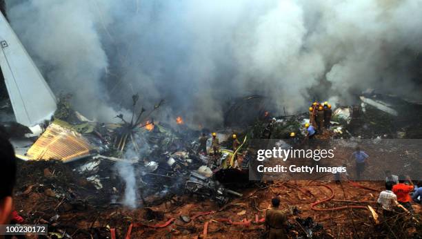 Firemen, para-military personnel and helpers at the site of the aircrash, on May 22, 2010 in Mangalore. An Air India Express Boeing 737-800 series...