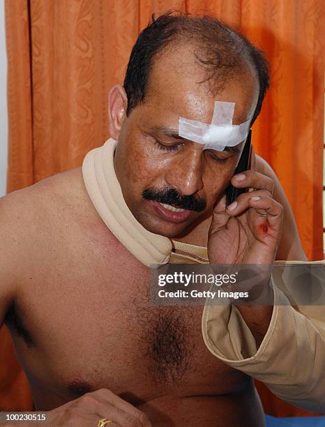 Survivor of the aircraft crash makes a call to his family, at the hospital, on May 22, 2010 in Mangalore. An Air India Express Boeing 737-800 series...