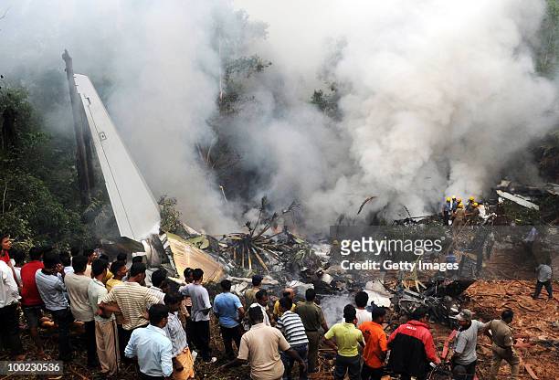 Smoke rises from the air plane crash site on May 22, 2010 in Mangalore. An Air India Express Boeing 737-800 series aircraft overshot the runway on...
