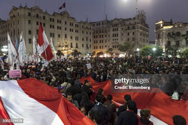 Demonstrators hold large Peruvian flags in Plaza San Martin during a protest demanding judicial reforms and accountability for corrupt judges in...