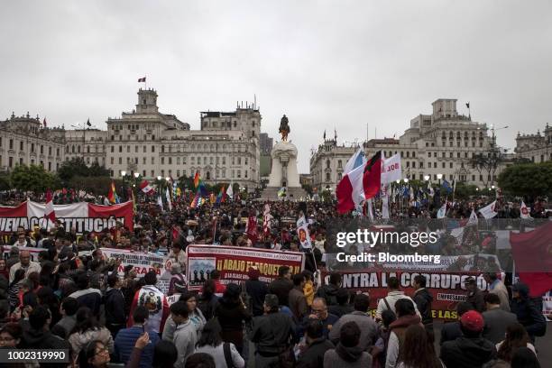 Demonstrators wave flags and banners at Plaza San Martin during a protest demanding judicial reforms and accountability for corrupt judges in Lima,...