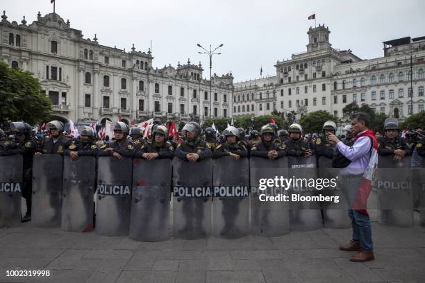 Police officers stand guard at Plaza San Martin during a protest demanding judicial reforms and accountability for corrupt judges in Lima, Peru, on...