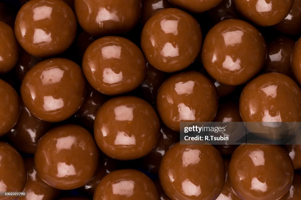 Multiple chocolate ball candies composition, isolated over the white background