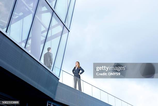 businesswoman on outside looking in - zenith building stock pictures, royalty-free photos & images