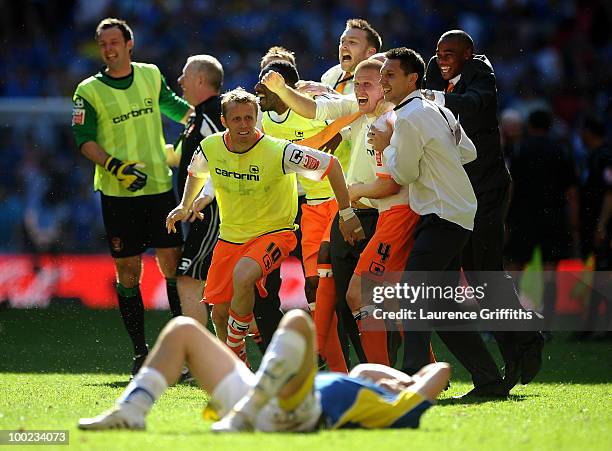 Brett Ormerod and Keith Southern of Blackpool lead the celebrations as Darcy Blake shows his disappointment during the Coca-Cola Championship Playoff...