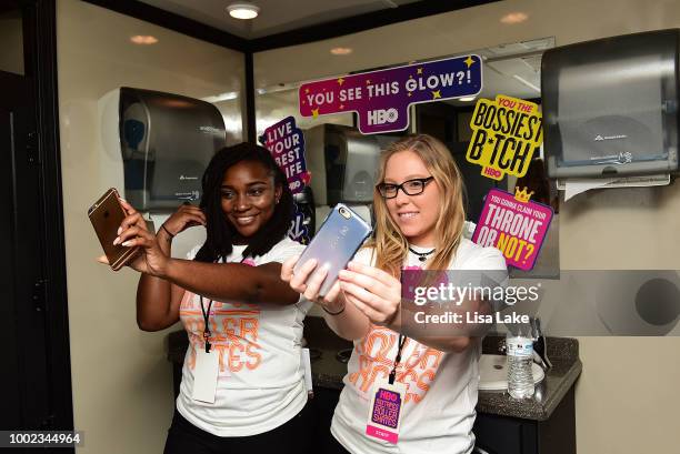 Guests take bathroom selfies in front of stickers featuring Bathroom Mirror Lyrics during HBO's Mixtapes & Roller Skates at the Blue Cross RiverRink...