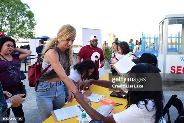 Guest entering event receive branded wristband during HBO's Mixtapes & Roller Skates at the Blue Cross RiverRink in Philadelphia, Pennsylvania on...