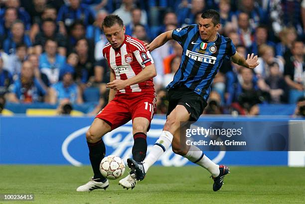 Ivica Olic of Bayern Muenchen is challenged by Lucio of Inter Milan during the UEFA Champions League Final match between FC Bayern Muenchen and Inter...