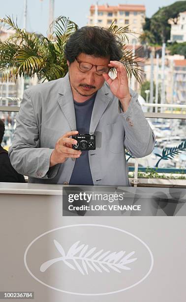 South Korean director Hong Sangsoo poses during the photocall "Ha Ha Ha" presented in the Un Certain Regard selection at the 63rd Cannes Film...