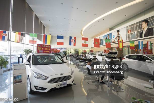 Ford Motor Co. Focus vehicle, left, stands on display at a Ford dealership in Shanghai, China, on Thursday, July 19, 2018. The fledgling U.S.-China...